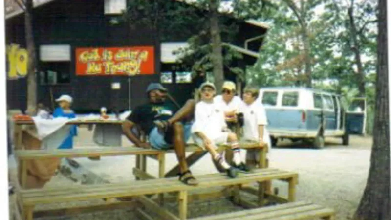 Camp counselors sitting on bleachers at Camp Barnabas