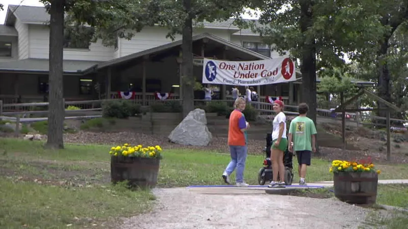 Camp counselors walking towards a bunkhouse at Camp Barnabas