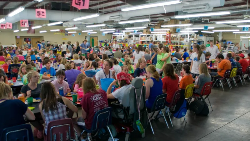 People playing a large bingo game at camp barnabas mess hall