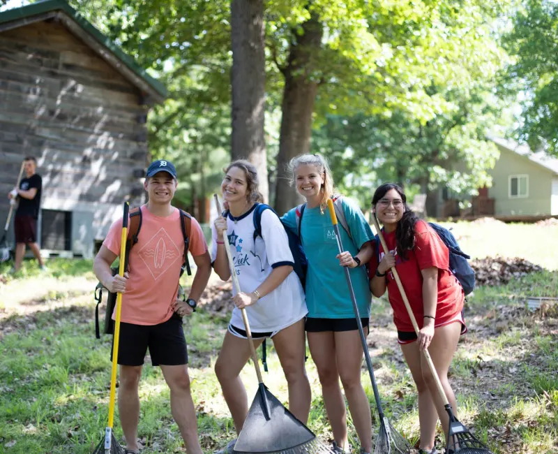 Campers raking leaves at summer camp